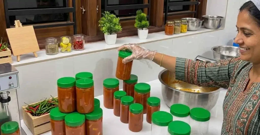 ndian woman preparing and packing homemade pickle jars for a small food business
