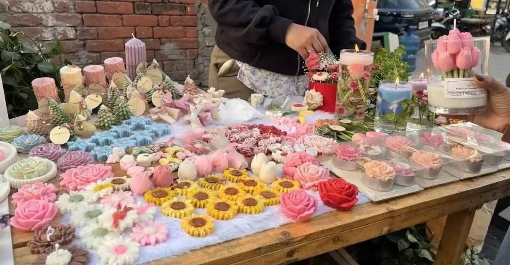 Indian woman explaining handmade scented candles to customers