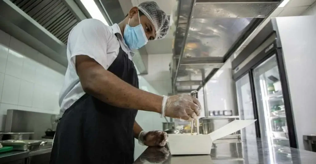 Cloud Kitchen Business के लिए शेफ ताजा खाना तैयार और पैक करते हुए